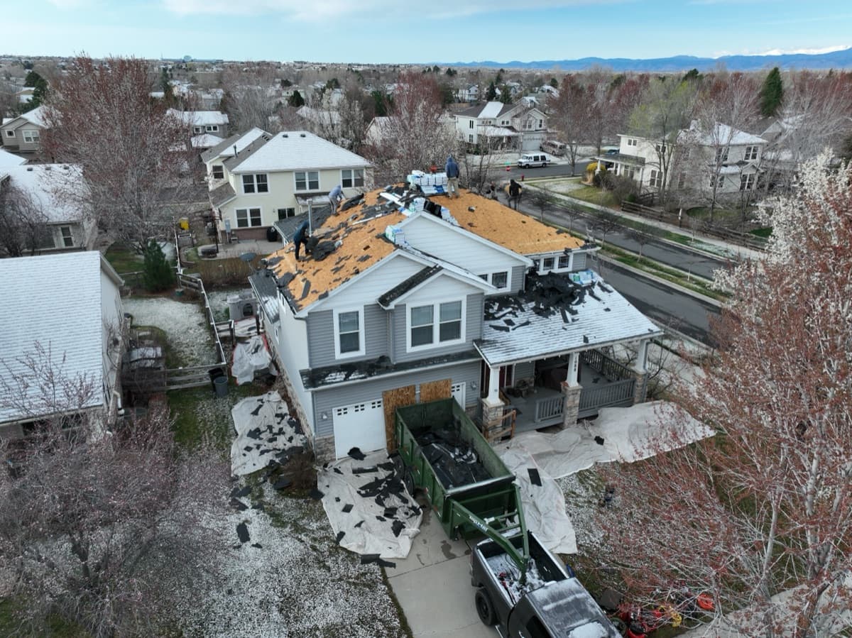 Aerial drone view of residential roof inspection