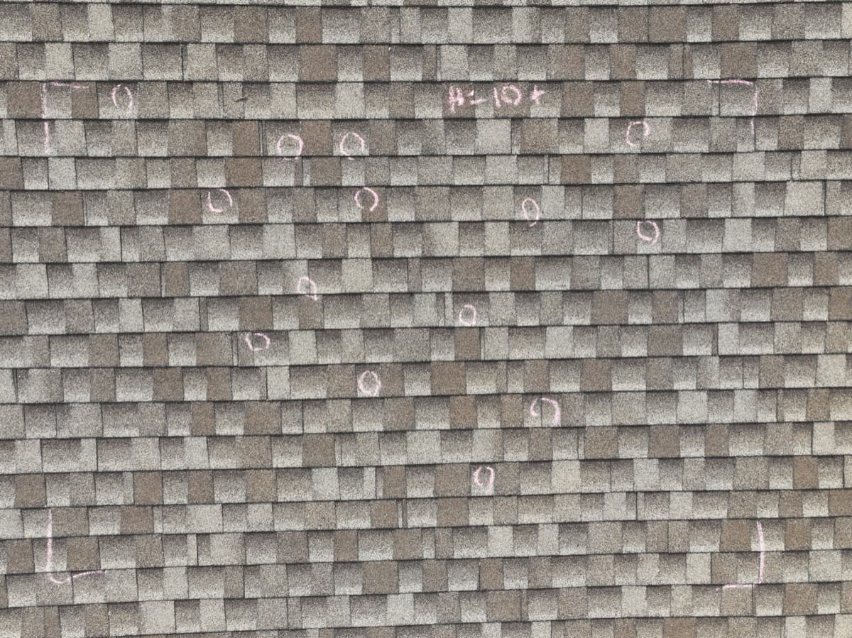 Hail test square showing impact damage warranting full roof replacement
