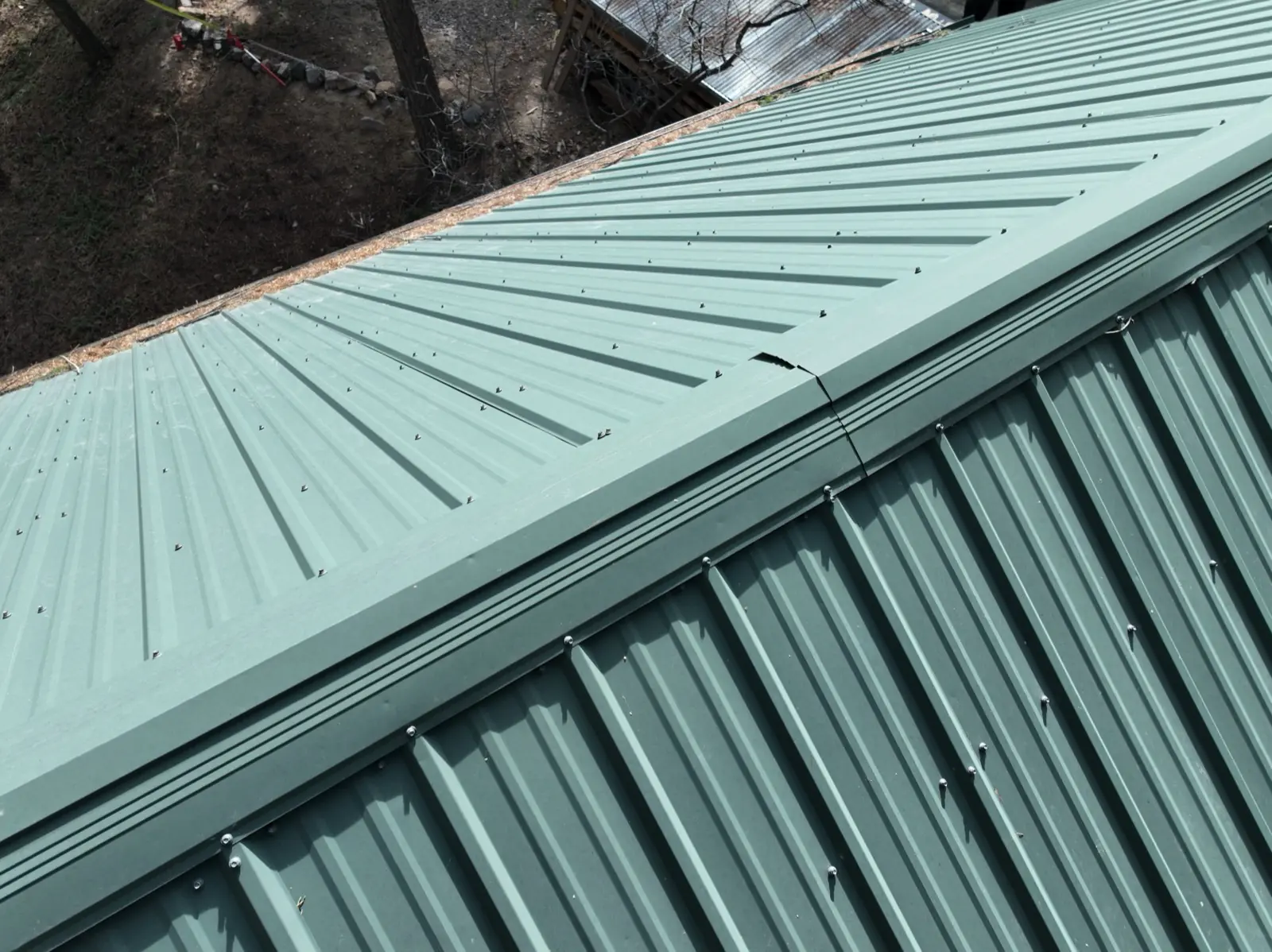 Hail damage on a metal roof in Colorado inspected by Gates Enterprises
