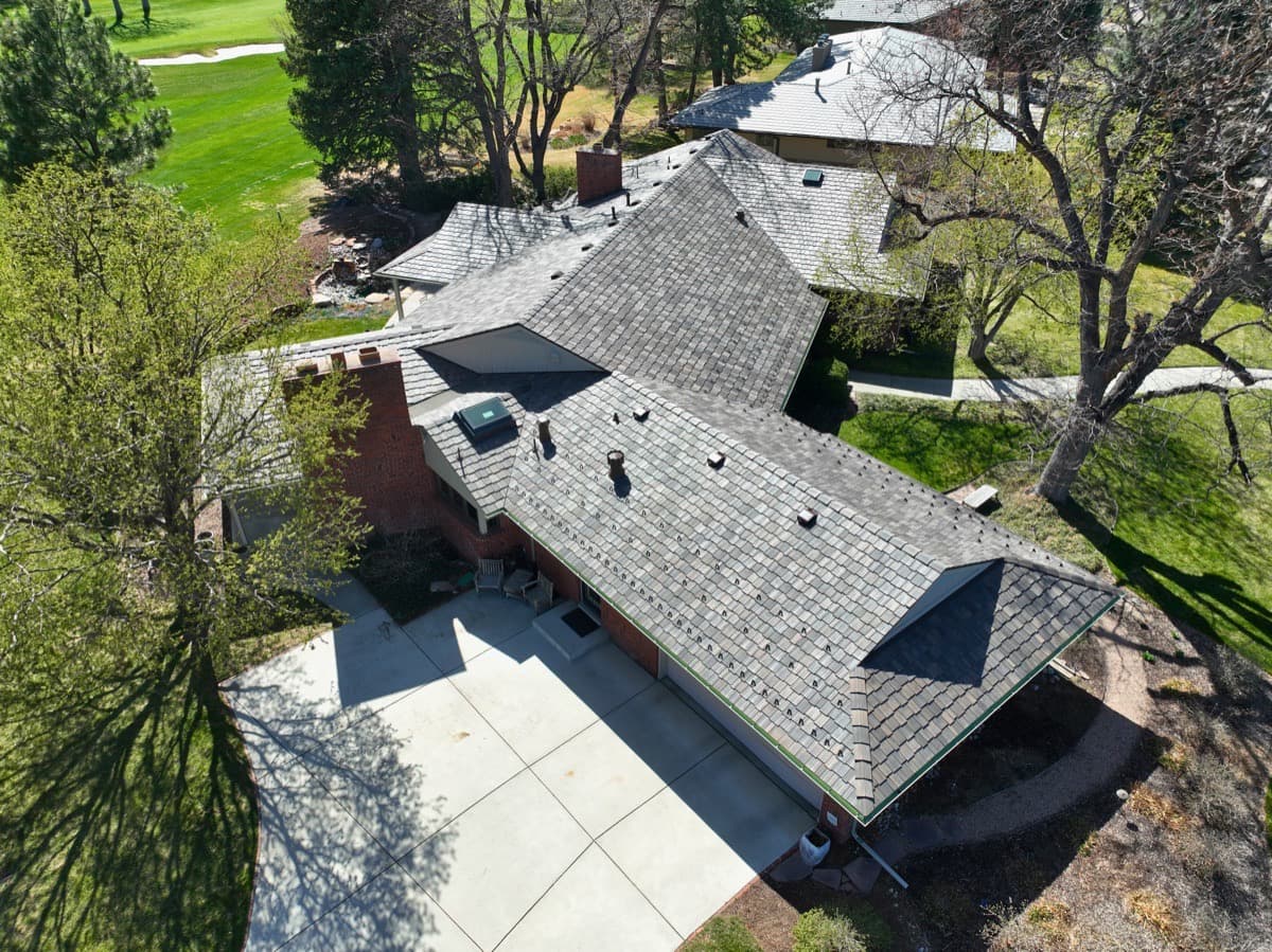Completed DaVinci synthetic slate roof near golf course with aerial view