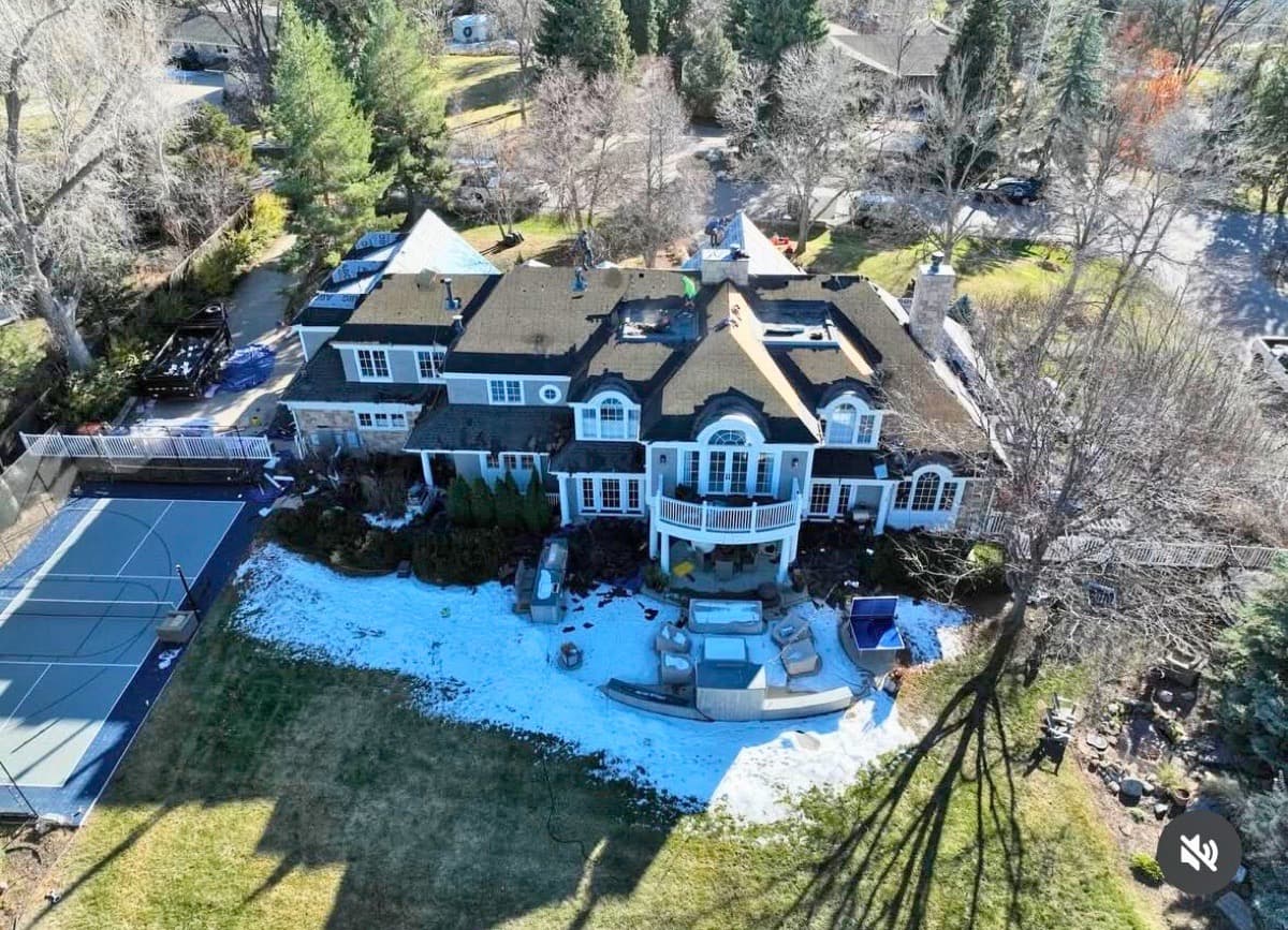 Large luxury estate with completed dark roof and tennis court